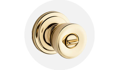 Kwikset Abbey Collection Knob product isolated on top of a gray circle